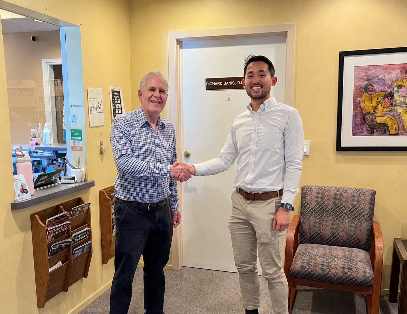 Dr. Richard Janis and Dr. Christopher Lee shaking hands at the practice