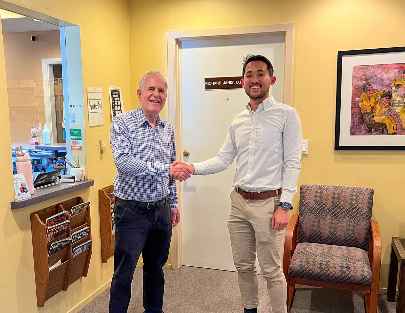 Dr. Richard Janis and Dr. Christopher Lee shaking hands at the practice